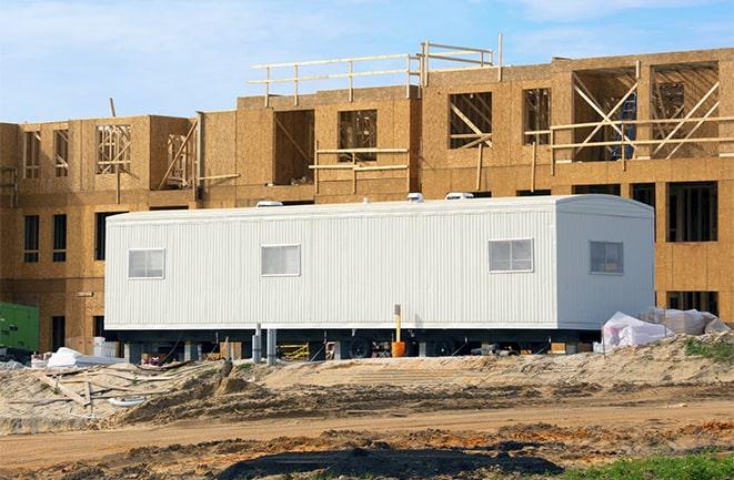 construction workers discussing plans in a rental office in Laurel, FL